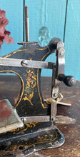 Antique German pressed tin child’s sewing machine.